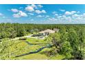 Overhead shot showcasing the house, driveway, and scenic pond at 20207 71St E Ave, Bradenton, FL 34211