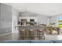 Well-lit kitchen boasts granite counters, stainless appliances, breakfast bar, seamlessly integrated with the dining area at 22025 Voltair Ave, Port Charlotte, FL 33954