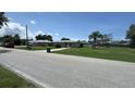 Street view of house with well-maintained lawns in a sunny neighborhood at 23067 Elmira Blvd, Punta Gorda, FL 33980