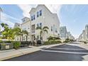 Charming townhome showcases a fenced-in patio, lush landscaping, and a well-maintained white exterior at 2500 Boone Ct, Sarasota, FL 34237