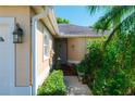 Inviting front entrance with a well-maintained walkway surrounded by lush greenery at 2511 Lantana Ln, Palmetto, FL 34221