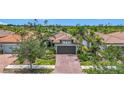 Beautiful single-Gathering home featuring mature landscaping, a tile roof, and a two-car garage at 2525 Daisy Dr, North Port, FL 34289