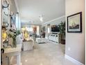 Bright living room with tile floors, a ceiling fan, and an open floor plan at 2525 Daisy Dr, North Port, FL 34289