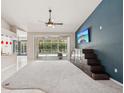 Bright living room with tile floors, neutral walls, and sliding glass doors offering serene pool views at 25433 Colon Dr, Punta Gorda, FL 33983