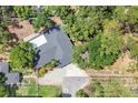 Bird's eye view of house showing roof, yard, and landscaping, highlighting the lot's shape and location at 2866 E Rainbow Cir, Sarasota, FL 34231