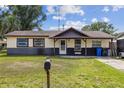 Charming single-story home with a well-maintained lawn and inviting front porch at 3211 Deerfield Dr, Tampa, FL 33619