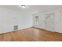Bright living room featuring hardwood floors, a window, and a front door at 3211 Deerfield Dr, Tampa, FL 33619