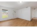 Bright living room featuring hardwood floors, a window, and a front door at 3211 Deerfield Dr, Tampa, FL 33619