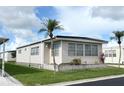 Cozy single-story home showcasing neat landscaping, large windows, and durable siding, surrounded by a lush green lawn at 3224 Aspen Ter, Sarasota, FL 34237