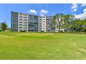 Exterior of building surrounded by a lush lawn and mature trees at 3680 Ironwood Circle # 704-L, Bradenton, FL 34209