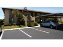 Attractive condo complex with covered parking, guest parking, and verdant landscaping for a welcoming appearance at 4016 Oakview Dr # J6, Punta Gorda, FL 33980