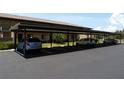 Condo complex parking area with shaded spots and guest parking for easy and accessible accommodations at 4016 Oakview Dr # J6, Punta Gorda, FL 33980