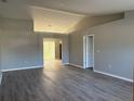 Bright living room featuring sleek laminate floors and fresh gray paint at 4031 Wake Ave, Sarasota, FL 34241
