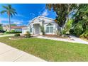 Beautiful single-story home featuring lush green lawn, well-maintained landscaping, and an inviting walkway at 4426 Useppa Dr, Bradenton, FL 34203