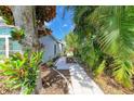 A serene paved walkway, framed by lush greenery and landscaping, offers a tranquil path through the property at 4426 Useppa Dr, Bradenton, FL 34203