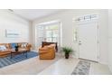 Inviting living room featuring bright light from the large bay window and a welcoming foyer at 4845 Post Pointe Dr, Sarasota, FL 34233