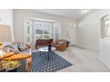 Inviting living room features bright light from the bay window and the front door at 4845 Post Pointe Dr, Sarasota, FL 34233