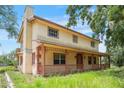 Spacious two-story home featuring a classic covered front porch, offering charming curb appeal at 5034 257Th E St, Myakka City, FL 34251