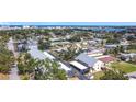 Aerial view of a condo complex with mature landscaping, covered parking and city views at 516 Parkdale Mews # 516, Venice, FL 34285