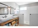 Modern bathroom featuring double sinks, a spacious walk-in shower with white subway tile, and ample natural light at 5419 Lakehurst Ct, Palmetto, FL 34221