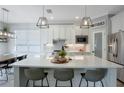 Bright kitchen with a large island, modern lighting, stainless steel appliances, and ample counter space at 5419 Lakehurst Ct, Palmetto, FL 34221