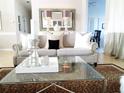 Inviting living room featuring stylish furniture, a glass coffee table, and neutral tones at 5449 Downham Mdws, Sarasota, FL 34235
