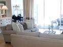 Bright living room with comfortable seating, stylish decor, and sliding glass door to patio at 5449 Downham Mdws, Sarasota, FL 34235