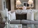 Cozy living room with elegant sofa, decorative pillows, and chic decor at 5449 Downham Mdws, Sarasota, FL 34235