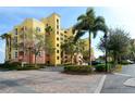 Beautiful condo building with well-manicured landscaping and a convenient parking area for residents and guests at 610 Riviera Dunes Way # 306, Palmetto, FL 34221