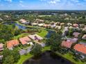 Aerial view of a beautiful home surrounded by lakes, trees, and golf course at 6851 Bay Hill Dr, Lakewood Ranch, FL 34202