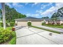 A spacious driveway and a two-car garage complement this exterior at 6908 Stoneywalk Ct, Bradenton, FL 34203