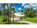 Spacious home boasts a large driveway, well-kept landscaping, and a three-car garage, close to the lake at 7404 Weeping Willow Blvd, Sarasota, FL 34241