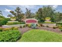 Palmer Oaks entrance sign, surrounded by lush landscaping and manicured hedges at 8417 Karpeal Dr # 4, Sarasota, FL 34238