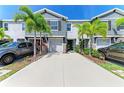 Townhome with well-maintained front yard, beautiful palm trees, and ample driveway parking at 8676 Ice Wine St, Sarasota, FL 34238