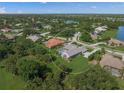 Spacious landscaped property with a pool, screened-in patio, and a view of the surrounding community at 8924 Misty Creek Dr, Sarasota, FL 34241