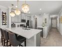 Bright, stylish kitchen featuring a large center island, pendant lights, and stainless steel appliances at 9012 Tequila Sunrise Dr, Sarasota, FL 34241
