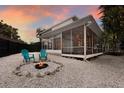 Inviting backyard with a shell-covered area, fire pit, and comfortable seating, perfect for outdoor relaxation at 9122 16Th Avenue Nw Cir, Bradenton, FL 34209