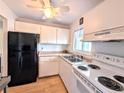 Cozy kitchen featuring white appliances, laminate floors, and ceiling fan at 1540 Pleasant Rd # G35, Bradenton, FL 34207