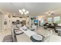Open-concept dining area with elegant chandelier, connecting to the kitchen and living room at 10609 Great Cormorant Dr, Riverview, FL 33579