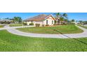 Expansive corner lot featuring a lush lawn and mature landscaping wrapping around the home's exterior at 1144 Hoover St, Nokomis, FL 34275