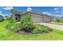 Beautiful landscaping surrounds the exterior of this well-maintained home with a two-car garage and charming curb appeal at 11685 Great Brook Ln, Parrish, FL 34219