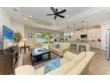 Inviting living room featuring an open floor plan, tile floors, and a scenic lake view at 138 Toscavilla Blvd, Nokomis, FL 34275