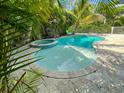 A luxurious pool area with spa provides a tranquil outdoor experience and ample patio space at 152 Coolidge Dr, Sarasota, FL 34236