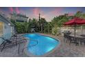 Private backyard oasis with sparkling pool, lounge chairs, and outdoor dining area at 160 Coolidge Dr, Sarasota, FL 34236