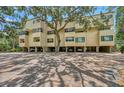 Unique condo exterior with private parking underneath and a grand shade tree at 1740 Alderman St # 7, Sarasota, FL 34236