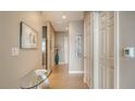 Long hallway with ceramic tile, artwork and a peek of stainless steel appliances at 1771 Ringling Blvd # 1206, Sarasota, FL 34236