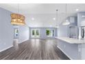 Bright living room featuring recessed lighting, gray flooring, and glass doors leading to the outdoors at 19185 Sherbrooke Ave, Port Charlotte, FL 33954