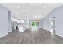 Open floor plan with tile flooring and modern fixtures featuring a kitchen with stainless steel appliances at 19185 Sherbrooke Ave, Port Charlotte, FL 33954