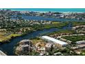 Stunning aerial view of a coastal community with waterfront property, lush greenery, and breathtaking ocean views at 1921 Monte Carlo Dr # 302, Sarasota, FL 34231