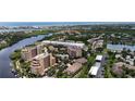 Stunning aerial view of the community with lush landscaping and bay views at 1921 Monte Carlo Dr # 302, Sarasota, FL 34231